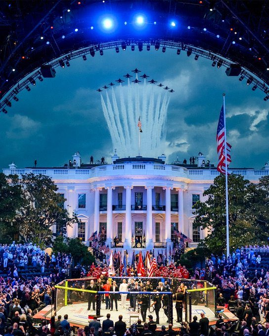 A vibrant scene at the White House featuring a large crowd and an octagonal ring at the center. Military jets fly overhead, creating smoke trails against a dramatic sky. The atmosphere is festive with flags and banners displayed prominently.